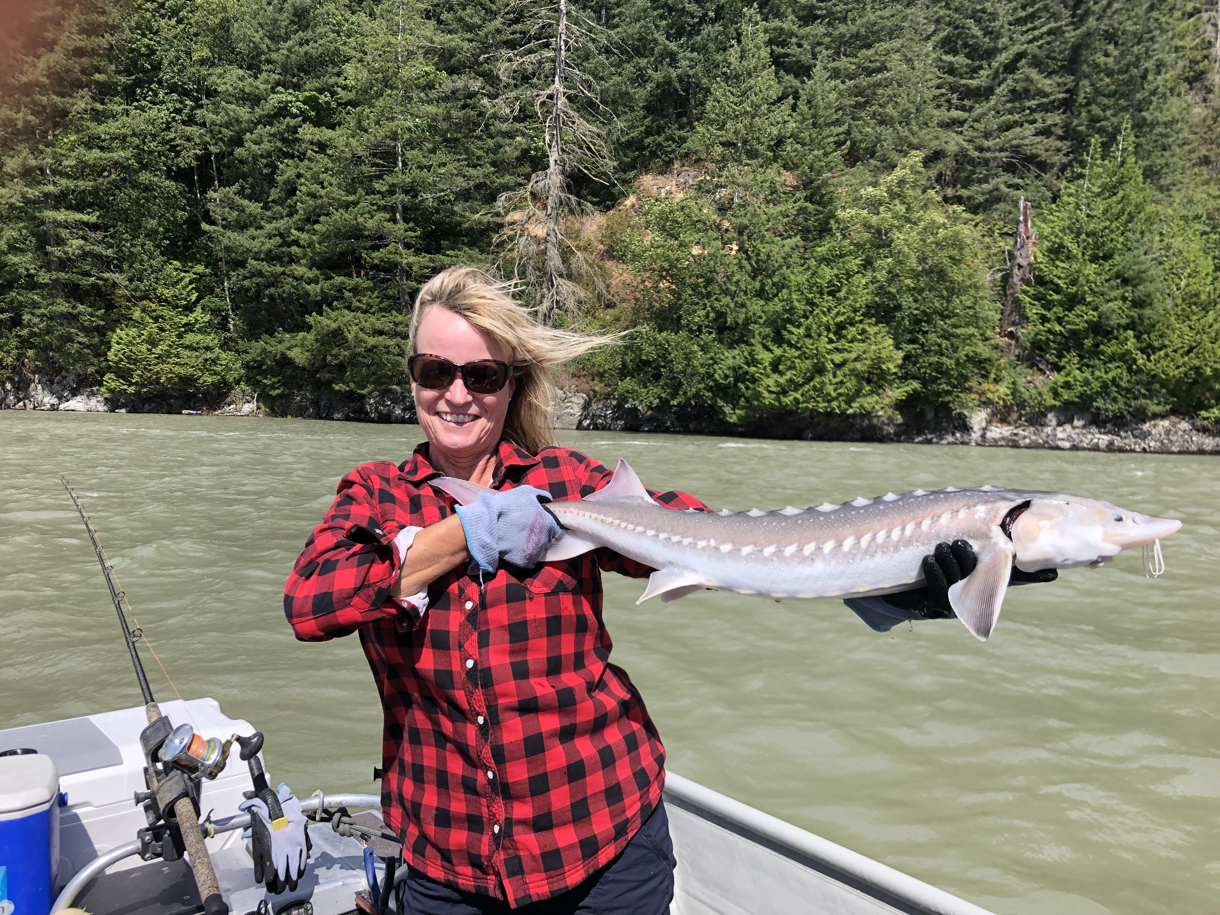 a lady holding a juvenile sturgeon